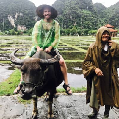 Aaron Scott riding water buffalo