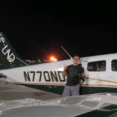 Adrian Calderon in front of airplane