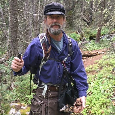 Steve Eagleburger in the woods foraging for mushrooms